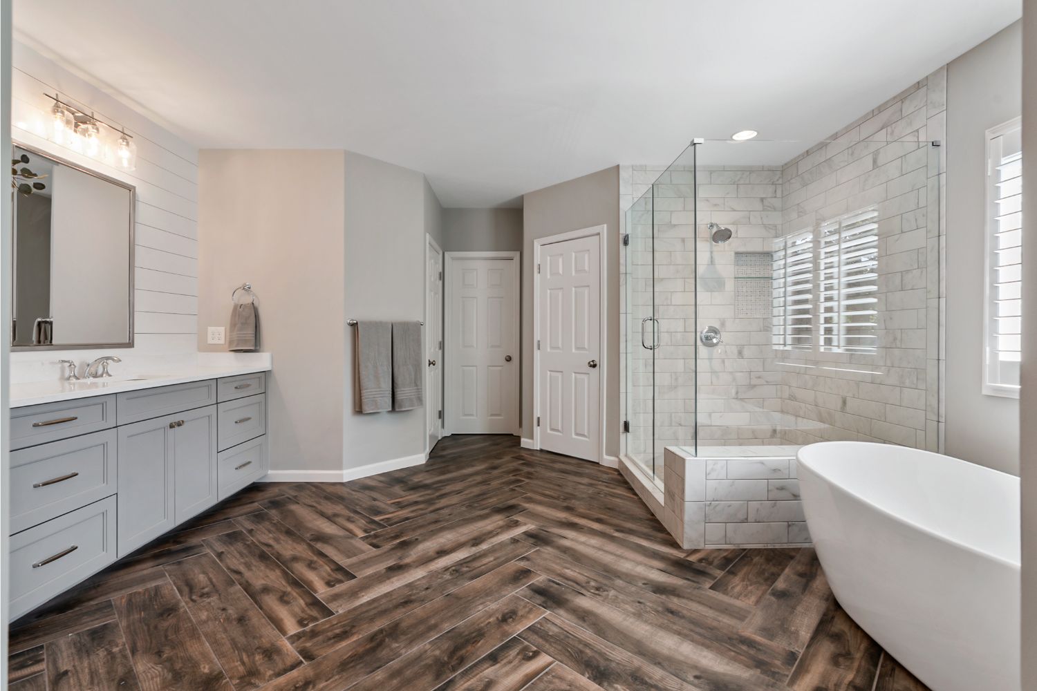 Beautiful master bathroom remodel, with wood look tile, layed in a herringbone pattern.
