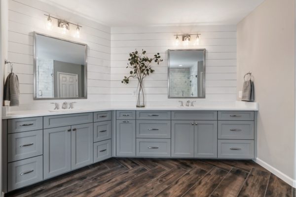 His and hers custom vanity, with shiplap walls, and metal framed mirrors.