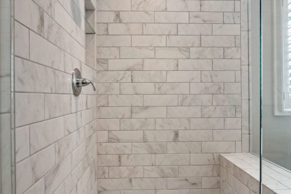 Custom tile shower with frameless glass surround.
