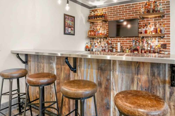 Custom bar with rustic barnwood panels, and stainless steel top.