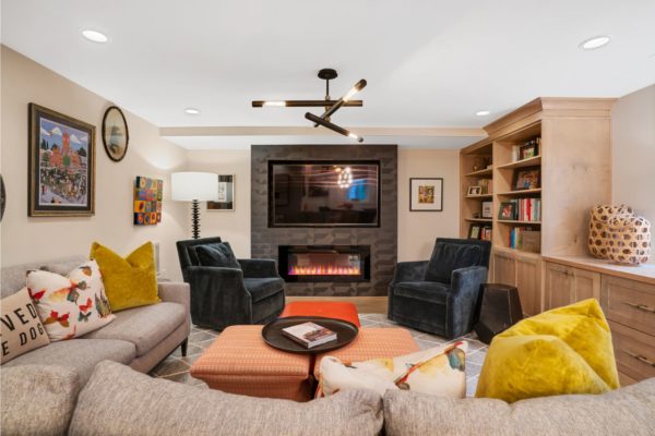 Cozy living space with electric fireplace in this finished basement.