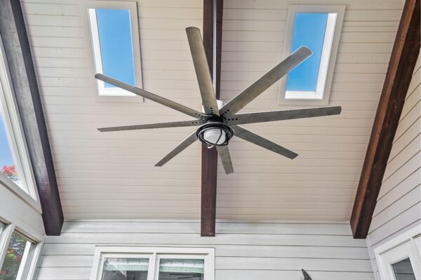Skylights and a large exterior ceiling fan bring comfort to this screened porch.