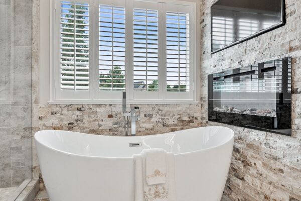Modern freestanding tub and faucet are spectacular in this master bath remodel.