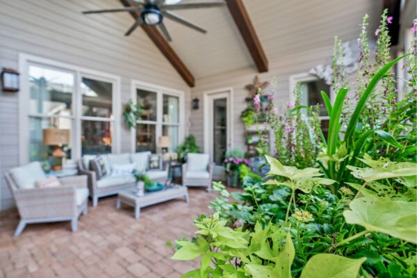 Beautiful plants decorate this new screened porch addition.