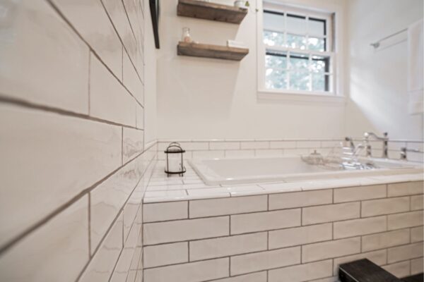 Textured subway tile creates a classic look in this master bath renovation.
