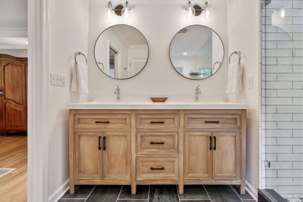 Furniture style vanity with double sinks, and drawers for storage.